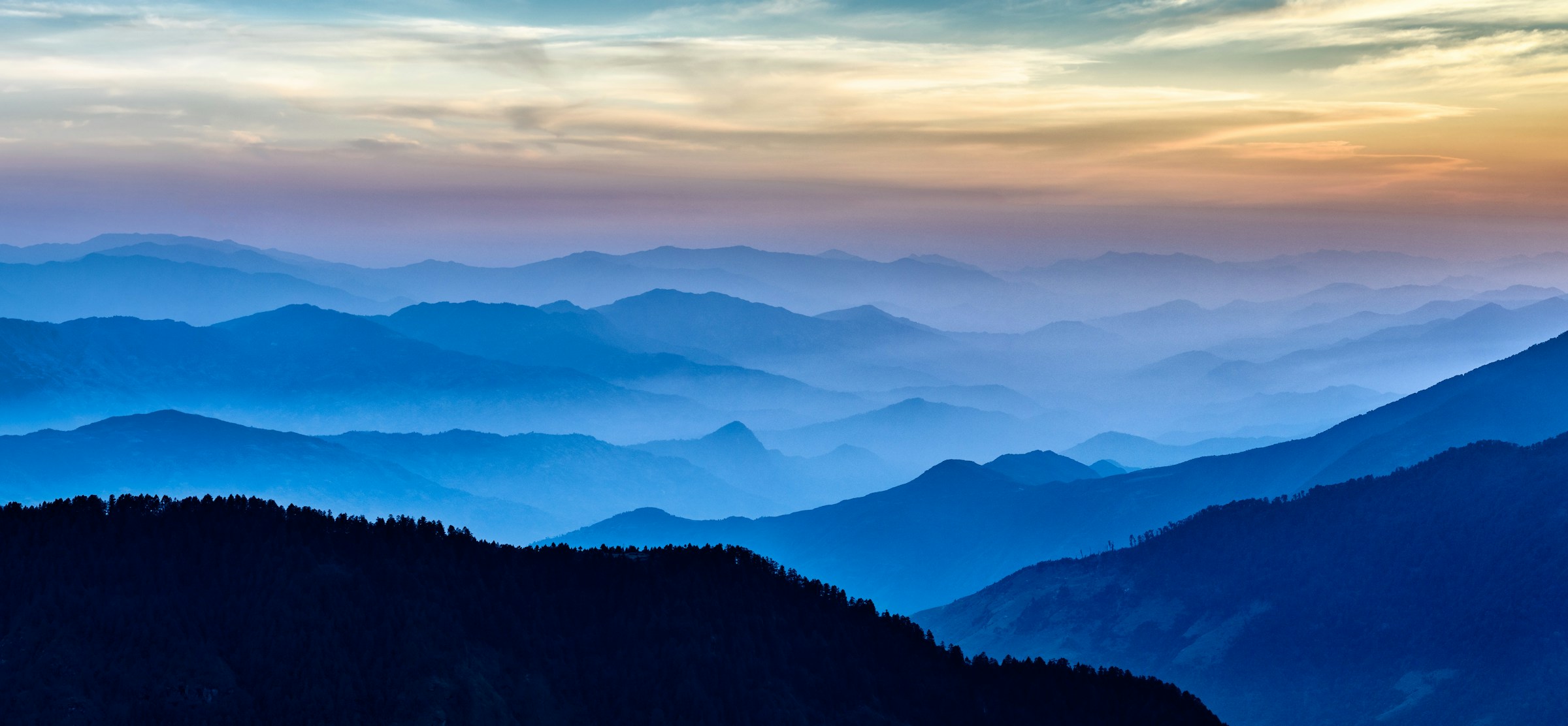 Looking down into a foggy mountain range at sunrise